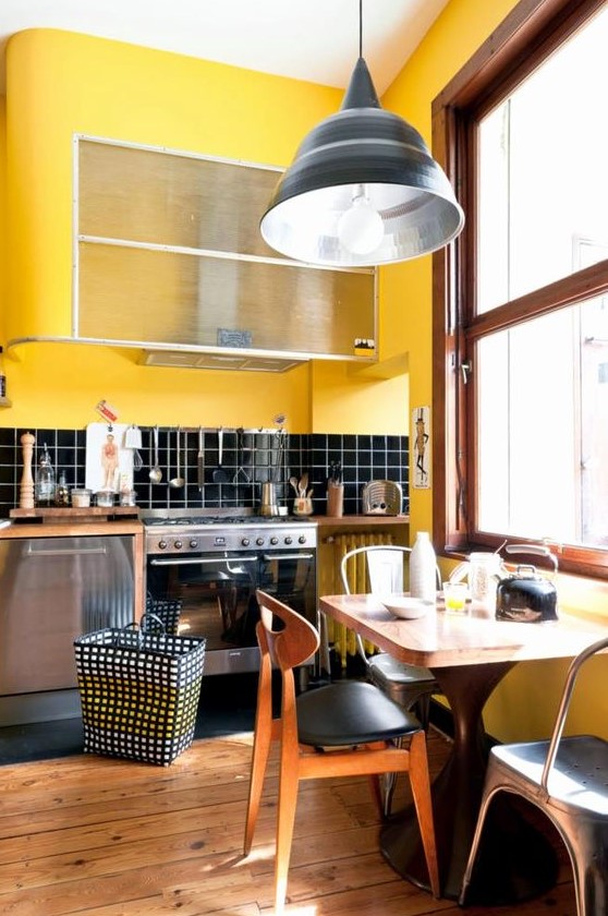 A retro kitchen done in bright yellow and black, with chic mid century modern furniture and touches of warm stained wood