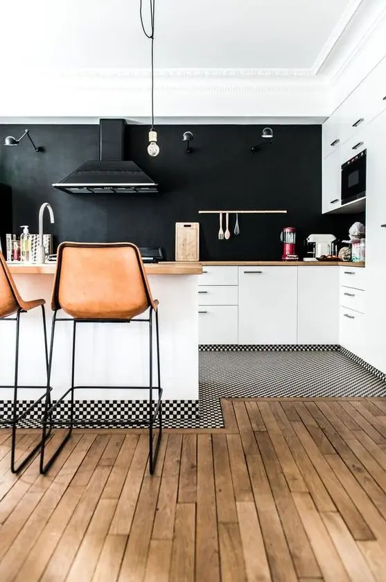 a welcoming white kitchen with butcherblock countertops and a chalkboard wall instead of a backsplash plus leather stools