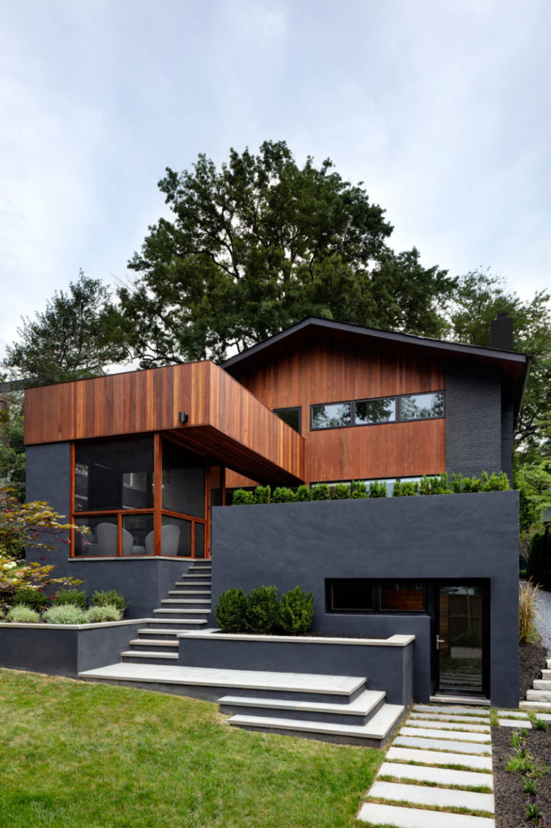The exterior of the house is done in black and rich colored wood