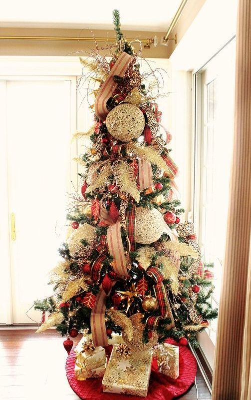 a bold and eye-catchy Christmas tree with striped and plaid ribbons, feathers, red and gold ornaments and oversized white ones