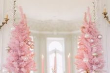02 mini pink Christmas trees with metallic and pastel ornaments and pink candles make the mantel super refined