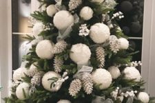 03 a bold Christmas tree with white berries, bleached pinecones and oversized white pompom ornaments for a cute look