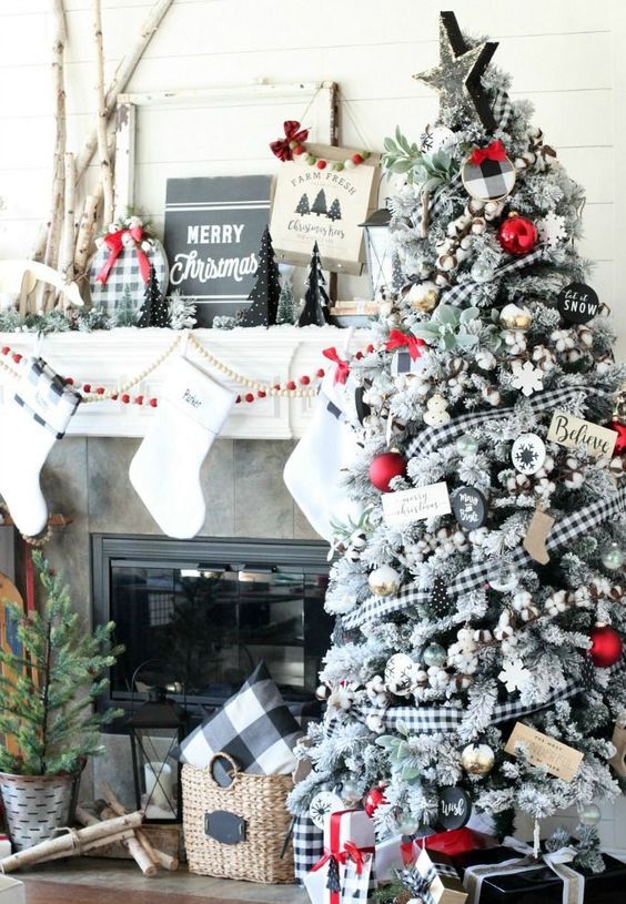 a flocked Christmas tree with cotton, buffalo check ribbons, red garlands and other touches for a contrast