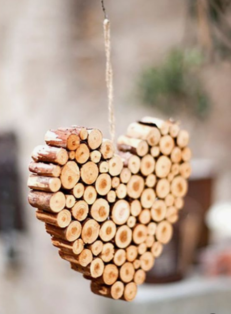 a heart-shaped Christmas ornament made of wood sticks and twine is very homey and you can easily DIY it