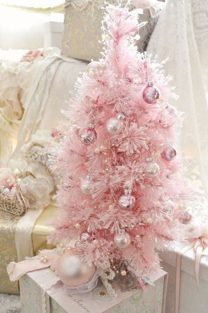 a pretty pink Christmas tree with shiny metallic ornaments that match in color and some pearly beads as decor