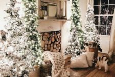 04 a cozy Christmas space with four flocked Christmas trees with lights looks really magical and very welcoming