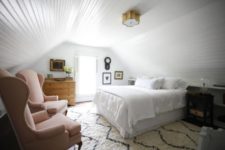 05 The bedroom is decorated with shiplap, there’s vintage furniture and amazing wingback chairs that add charm