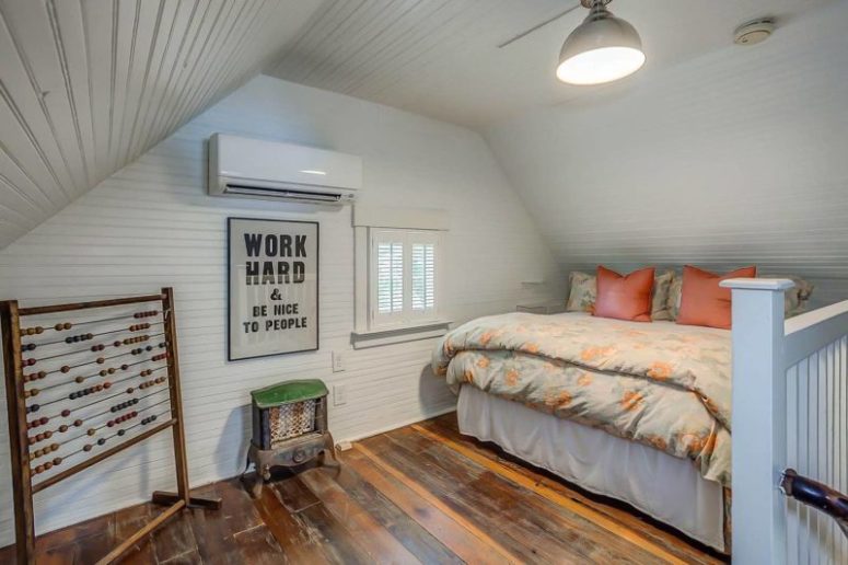 The guest bedroom is a small attic space with a decorative hearth table, a small bed and a little window with shutters