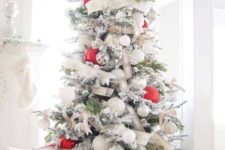 06 a chic flocked Christmas tree with white and burlap ribbons, white and metallic ornaments and oversized red ones