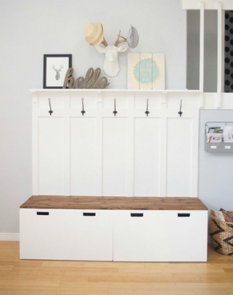 an IKEA mudroom bench with storage made of IKEA STUVA benches and Svartsjon hooks plus a wooden seat for a contrasting touch