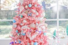 07 a bright candy-colored Christmas tree with bold blue ornaments, ice cream and popsicle ornaments and a candy topper