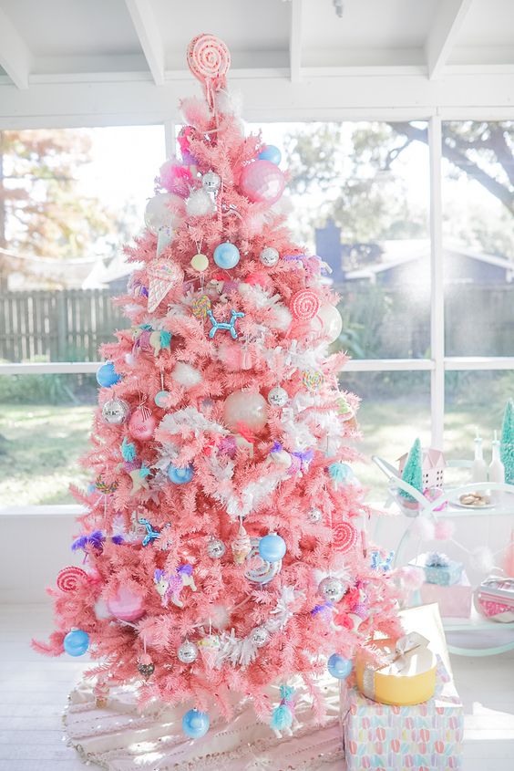 a bright candy-colored Christmas tree with bold blue ornaments, ice cream and popsicle ornaments and a candy topper