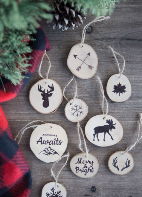 a variety of wood slice Christmas ornaments with images done in black paint can be made by you with stumps or you can paint