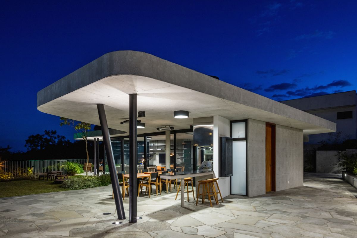 Two slightly angled steel columns support the roof overhang, forming a cozy outdoor terrace