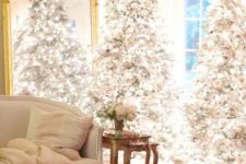08 a duo of flocked Christmas trees with lots of lights and neutral and silver ornaments is amazing for a chic space