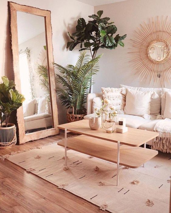 a super welcoming and cozy warm neutral living room with light-colored wood and lots of greenery in pots