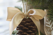 10 elegant rustic Christmas ornaments of pinecones and silk bows on top is a traditional Christmas decoration
