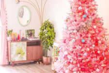 11 a bright pink Christmas tree with pastel and metallic ornaments and a large gold star topper for infusing your space with color