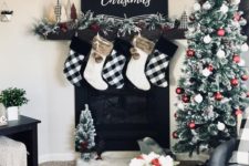 13 buffalo check and white stockings with faux fur, buffalo check bows and fake trees for Christmas