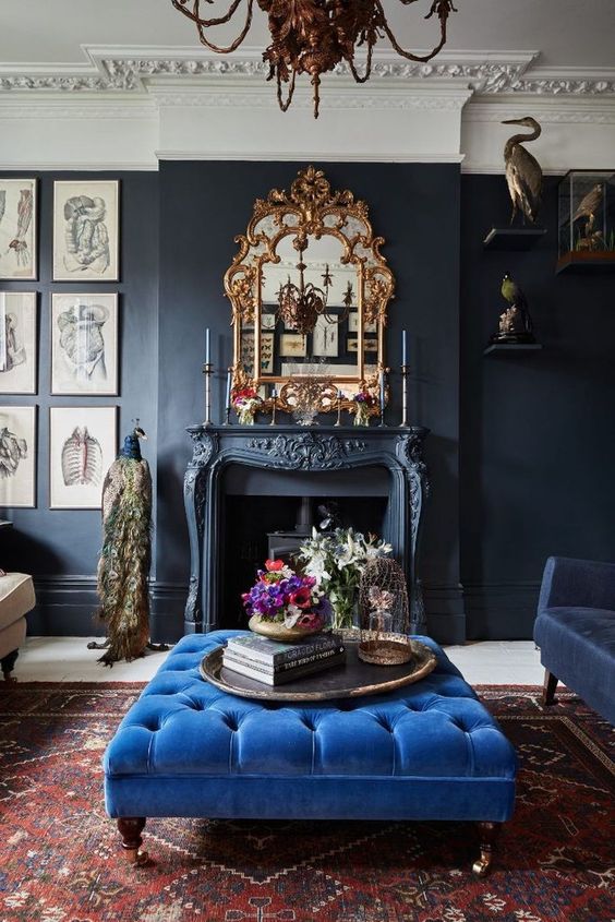 a refined and chic living room with a classic blue ottoman that adds color and a bold touch to the space
