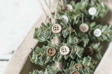 14 rustic Christmas ornaments made of sticks, evergreens, buttons and twine are easy and cool for any Christmas tree
