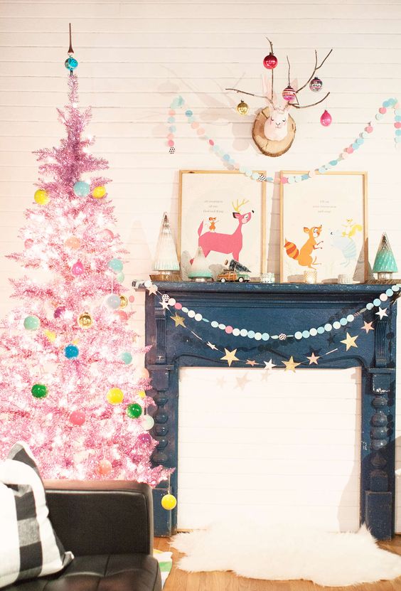 a hot pink tinsel Christmas tree with lights and colorful ornaments is a bright touch for your holiday space