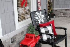 15 buffalo check pillows and red touches make this front porch vintage and very Christmas-like