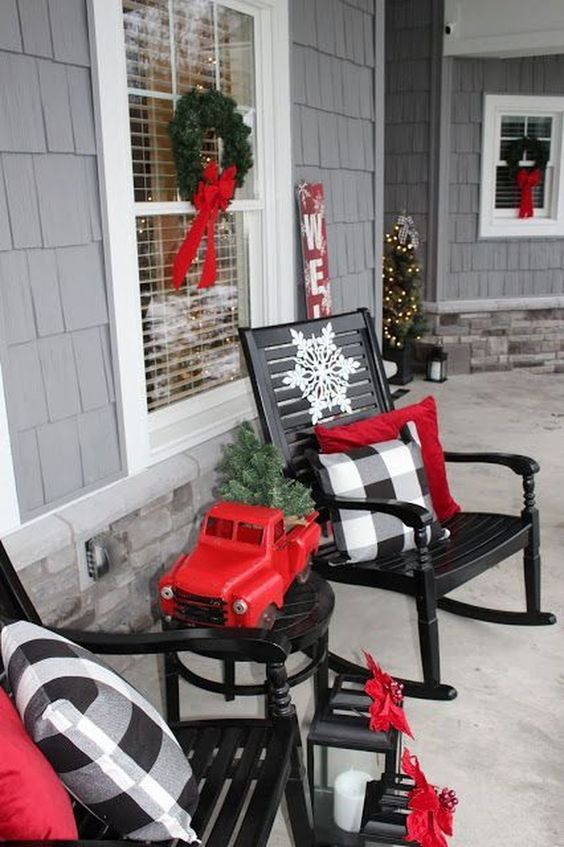 buffalo check pillows and red touches make this front porch vintage and very Christmas-like