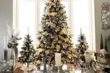 16 a trio of elegant and chic Christmas trees decorated with lights and white and silver ornaments and feathers