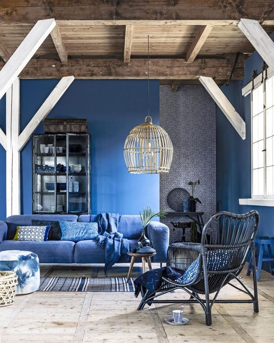 a beautiful classic blue living room with walls and a sofa plus grey touches for a chic and cool look
