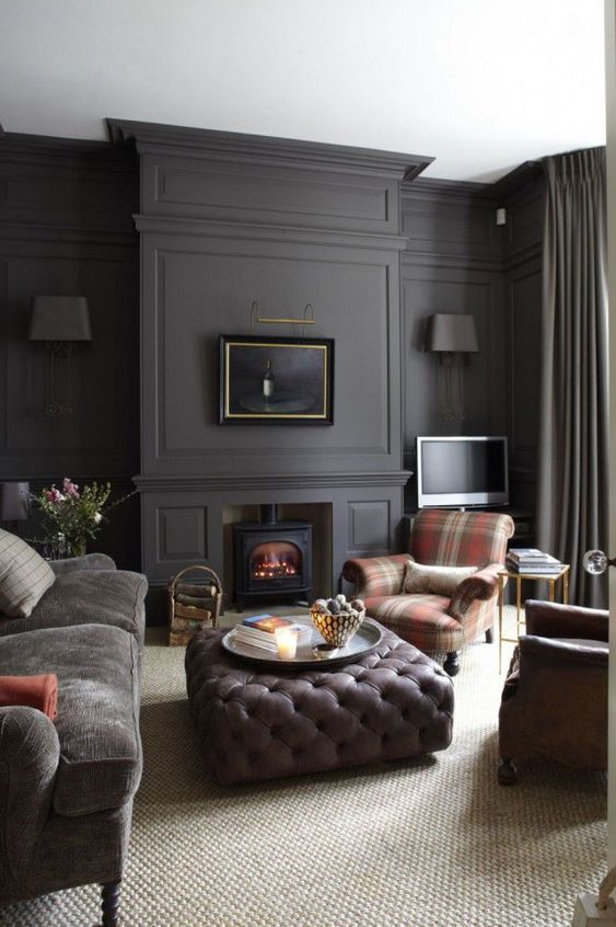 a moody living room with graphite grey walls and muted and subdued tones everywhere else