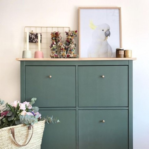 a sleek green entryway console of an IKEA Hemnes shoe cabinet and brass knobs plus a wooden tabletop for a more chic look