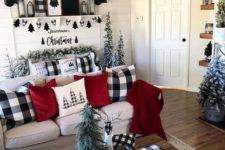 17 buffalo check pillows, a tablecloth, an artwork and a mix of black and white for bold Christmas decor