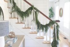 19 an evergreen garland with neutral silk bows to decorate the railing is a stylish and beautiful idea