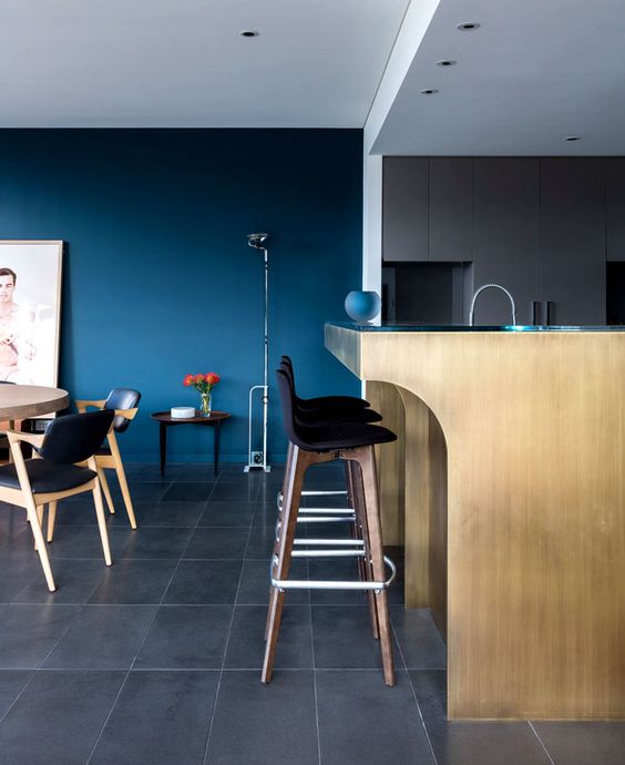 a contemporary space with an accent classic blue wall that brings a mood and color to the layout