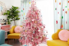 20 a pink Christmas tree with colorful retro ornaments, garlands and bead garlands adds even more color