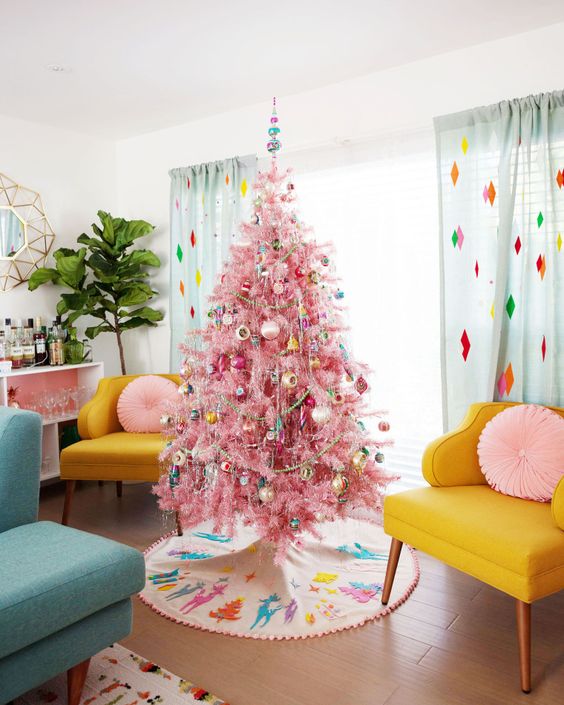 a pink Christmas tree with colorful retro ornaments, garlands and bead garlands adds even more color