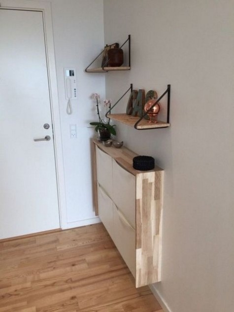 a sleek entryway console of an IKEA Trones item with a plywood waterfall countertop for a contemporary look