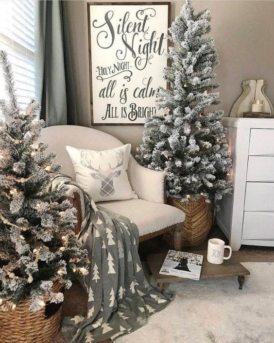 two flocked Christmas trees with lights placed into baskets are nice for a cozy farmhouse feel in the space