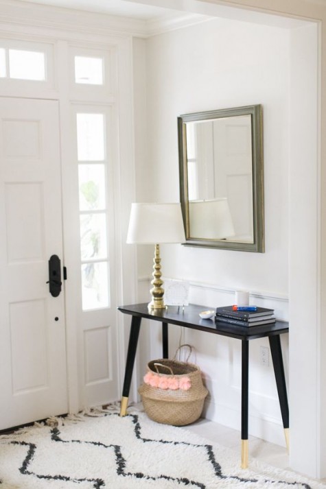 an IKEA Lisabo desk hacked into a stylish entryway console with just some gold paint on the legs