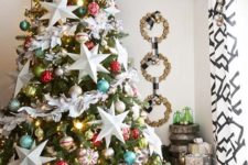 22 a bright Christmas tree with colorful ornaments, lights and oversized white stars looks catchy