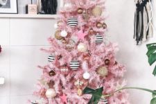 24 a pink Christmas tree with vine, black and white ornaments, copper and gold ones and a star topper
