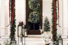 24 an evergreen garland over the porch with ribbons and bows, evergreen wreaths with pinecones and snowy Christmas trees