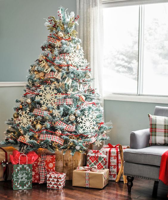 a rustic Christmas tree with checked ribbons, metallic ornaments and oversized snowflake ones
