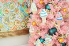 25 a tabletop pink Christmas tree with ice cream ornaments, marigold and teal ones of various sizes