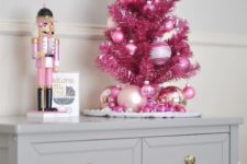 26 a tiny hot pink tinsel Christmas tree with bright pink glitter ornaments is a nice tabletop version of a usual one