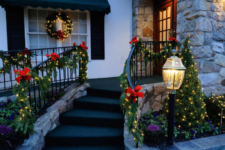 26 outdoor railings interwoven with lights and decorated with red bows will make your porch really festive and bright