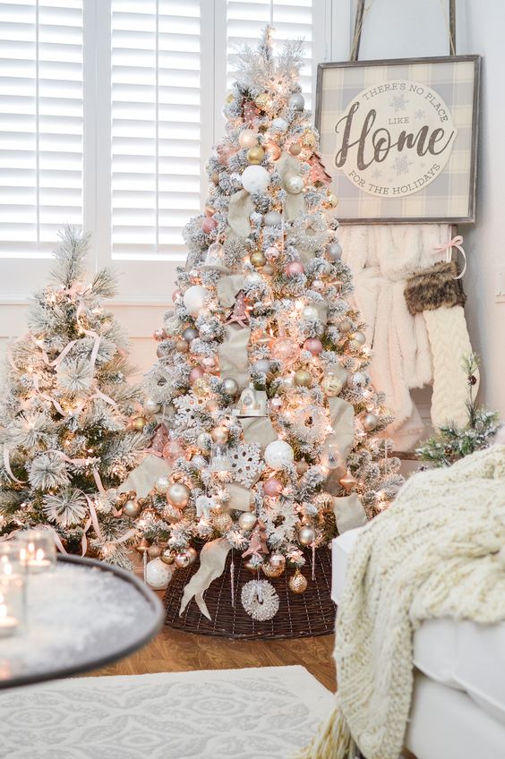 two cute snowy Christmas trees with lights, pastel and metallic ornaments and some stripes for a glam touch