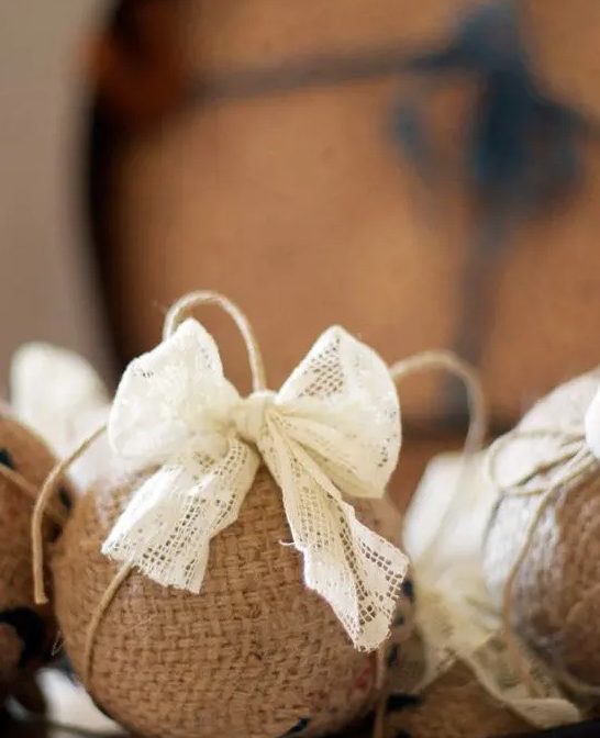 A burlap ornament with a lace bow is a cute vintage inspired and rustic decoration
