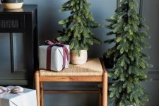 a duo of Christmas trees in planters is a cool solution for a modern or Scandinavian space
